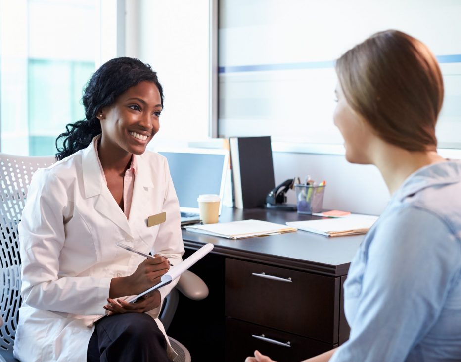 Doctor In Consultation With Female Patient In Office Healthcare Staffing Agency