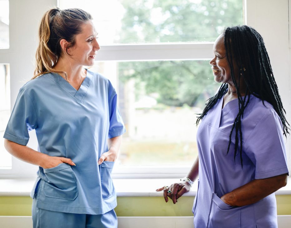 Nurses having a conversation in the hospital hallway